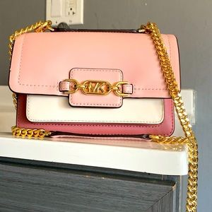This is a Michael Kors shoulder bag in the color, rose tan
